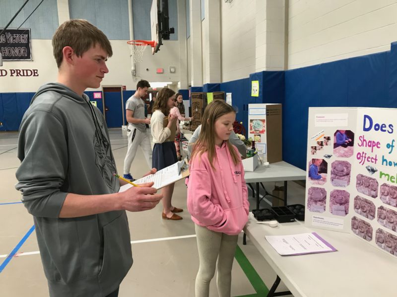 High School Student Judging Science Fair Projects