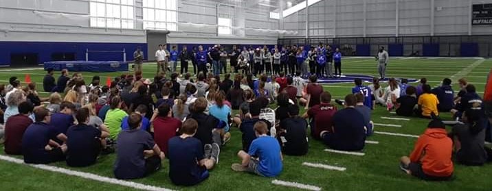 CLCS Track and Field athletes learning from UB athletes at an indoor clinic