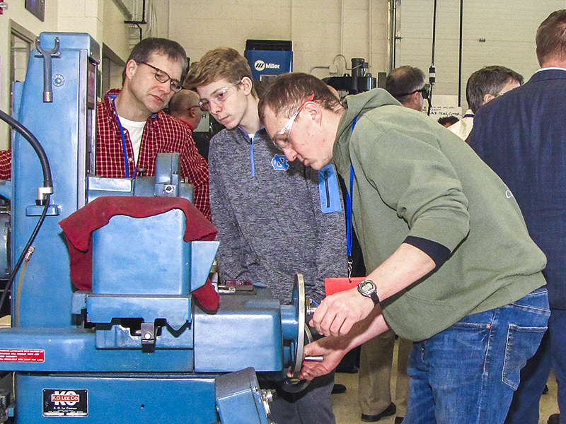 Students looking at machines in the Manufacturing Lab