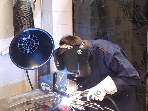 Student welding in Manufacturing Lab